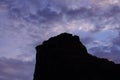 Desert Rock Pinnacle Silhouette Against Blue and Purple Sky Royalty Free Stock Photo