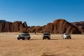 Desert safari, cars standing in front of rock formation, Chad Royalty Free Stock Photo