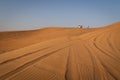 Desert safari tour in UAE. Four wheel drive desert safari car on a san dune with a tourists Royalty Free Stock Photo