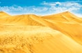Desert with sand dunes and clouds on blue sky Royalty Free Stock Photo