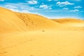 Desert with sand dunes and clouds on blue sky Royalty Free Stock Photo