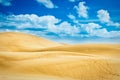 Desert with sand dunes and clouds on blue sky Royalty Free Stock Photo