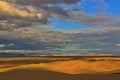 Desert Sand Dunes with Mountains in the Background Royalty Free Stock Photo