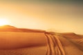 Desert sand dunes road at sunset Royalty Free Stock Photo