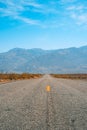 Desert scenic road in Death Valley with mountain backdrop, California, USA. Amazing natural panorama Royalty Free Stock Photo