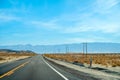 Desert scenic road in Death Valley with mountain backdrop, California, USA. Amazing natural panorama Royalty Free Stock Photo