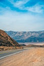 Desert scenic road in Death Valley with mountain backdrop, California, USA. Amazing natural panorama Royalty Free Stock Photo