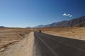 Desert scenic view of high mountain winding road and cars against the background of rugged mountain wall , Ladakh, Himalaya, India