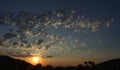 Desert sky at sunset. Golden with clouds.