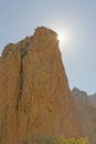 Desert Sun Peaking Around a Rock Monolith