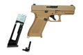 Desert tan pneumatic air pistol with magazine and tool on white back Royalty Free Stock Photo