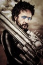 Desert warrior with big gun wearing a latex armor Royalty Free Stock Photo