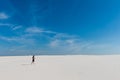 Mysterious girl walk far with aquarium in desert Royalty Free Stock Photo