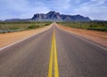 Desert wilderness road leading to mountain. Royalty Free Stock Photo