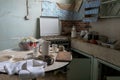 Deserted and abandoned house kitchen with kitchenware on the room. Forgotten home