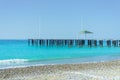 Deserted abandoned pier with blue water