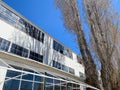 Deserted abandoned wharf seaside warehouse dock building with winter weather trees Royalty Free Stock Photo