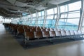 Deserted airport terminal. Rows of empty seats in the waiting room Royalty Free Stock Photo