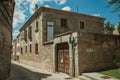 Deserted alley and old building with wooden door at Avila