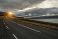 A deserted asphalt road running away into the hills. Iceland. The spirit of travel and adventure. Royalty Free Stock Photo