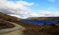 A deserted asphalt road running away into the hills. Iceland. The spirit of travel and adventure. Royalty Free Stock Photo