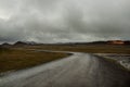 A deserted asphalt road running away into the hills. Iceland. The spirit of travel and adventure. Royalty Free Stock Photo