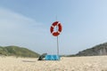 Deserted beach on the Atlantic coast. Lifebuoy on the pole. Neighborhood of Lisbon, Portugal