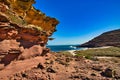 Deserted beach, bordered by layered sandstone rocks, Kalbarri, Western Australia