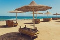 Deserted beach with wattled sun umbrellas. Royalty Free Stock Photo