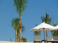 Deserted beach, white sand, sun loungers, parasols