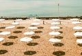 Deserted beach with white umbrellas Royalty Free Stock Photo