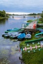 Deserted boat station in the evening. Jetty by the water, lifebuoys and boats at dusk