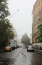 A deserted city street in foggy weather