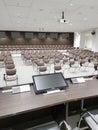 deserted conference room with empty brown chairs alert monitor white press center Royalty Free Stock Photo