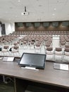 deserted conference room with empty chairs brown chairs alert monitor white press center Royalty Free Stock Photo