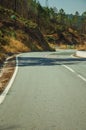 Deserted curve road through hilly landscape