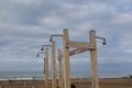 Deserted and Desolate Beach in Winter Time - Empty Structure and Piping for Showers
