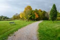 Empty gravel path in a park under storm clouds in autumn