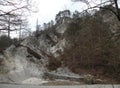 A deserted gray rocky landscape covered with spruce and spruce spruce and pine trees that have been damaged. A region like moon