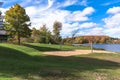 Deserted lakesside park with a sand volleyball court on a sunny autumn day Royalty Free Stock Photo