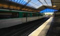 Deserted metro station in Paris with a passing train