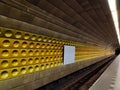 Deserted metro tube with yellow structured wall