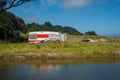 Deserted old caravan beside stream