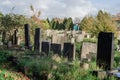 Deserted old graveyard with different style headstones and untended greenery Royalty Free Stock Photo
