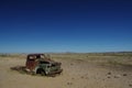 Deserted old Rusty car wreck deserted in the Namibia desert near death Valley signifying loneliness. Royalty Free Stock Photo
