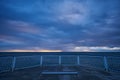 deserted pier with dramatic sky over stormy dark sea at sunrise Royalty Free Stock Photo