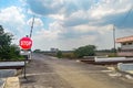 a deserted railroad crossing with no vehicles passing by. Translation on sign text \