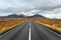 Deserted Road in Iceland with Snow Covered Mountains on the Horizon Royalty Free Stock Photo