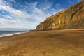 Sunlight lights the copper cliffs at Whale Chine in The isle of wight, England Royalty Free Stock Photo