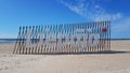 Deserted sandy beach on Baltic Sea and name of Latvian city Liepaja during Covid 19 on sunny day in April 2020